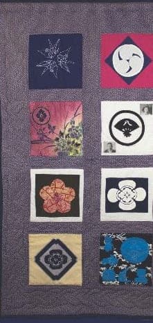 A quilt from the Colorado Japanese American Women’s Quilt Project: eight squares, each showing a family crest